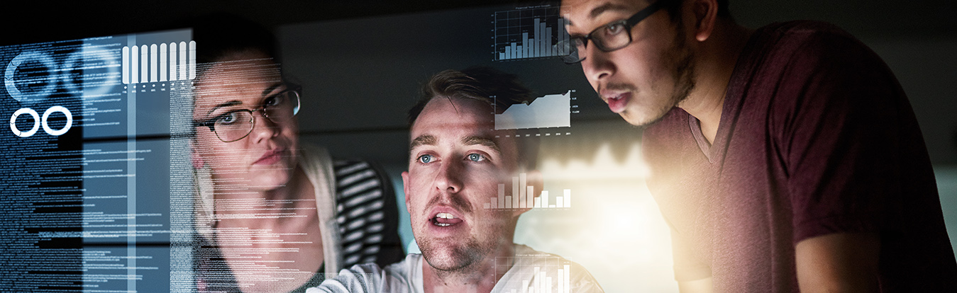 Three people looking at computer graphics