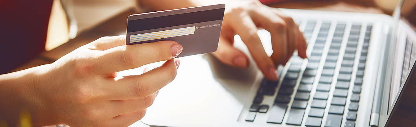 Image of someone using their credit card to make purchases online.