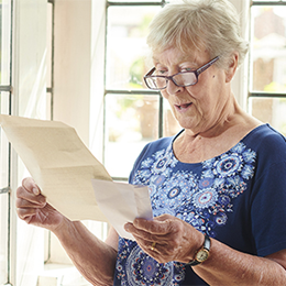 A senior woman reading her mail