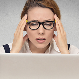 Concerned woman looking at laptop screen.